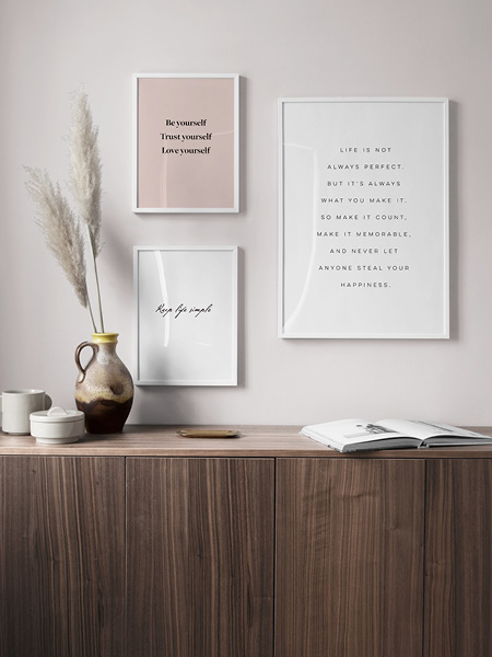 Modern text posters. Three prints with quotes and sayings framed on a wall. 