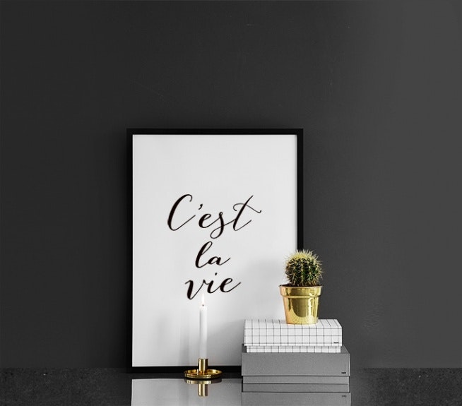 Black and white poster against a gray and gold interior design