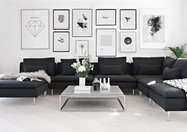 Large gallery wall with posters and prints in cleanly designed living room